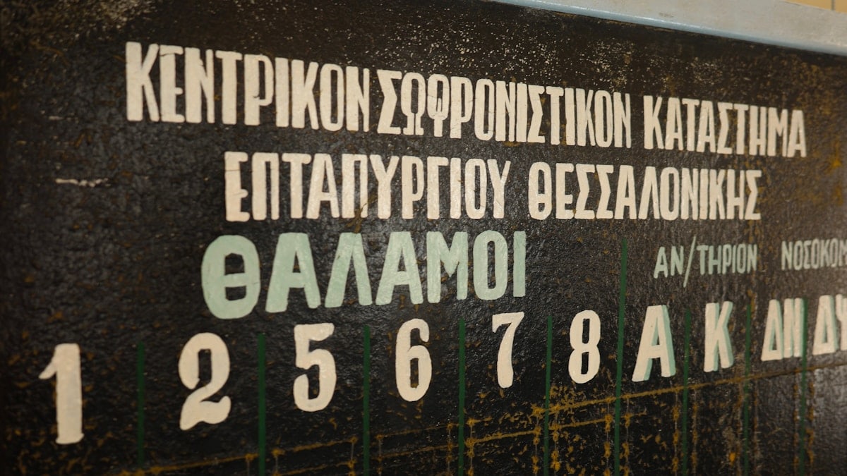 Greek text and numbers are visible on a blackboard.